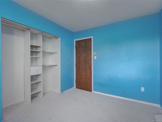 Unfurnished bedroom with light carpet, a closet, and a textured ceiling | Image 17
