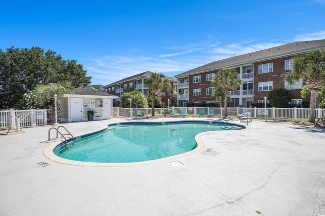 Community pool with a patio area | Image 24