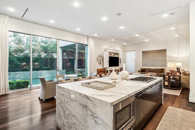 From a corner of the Kitchen, a view of the Breakfast area and the backyard beyond. Beyond is the Family Room - a great plan for the chef to enjoy all indoor and outdoor activities while busy creating fabulous cuisine! | Image 11