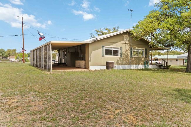 Back of house featuring a yard and a carport | Image 4