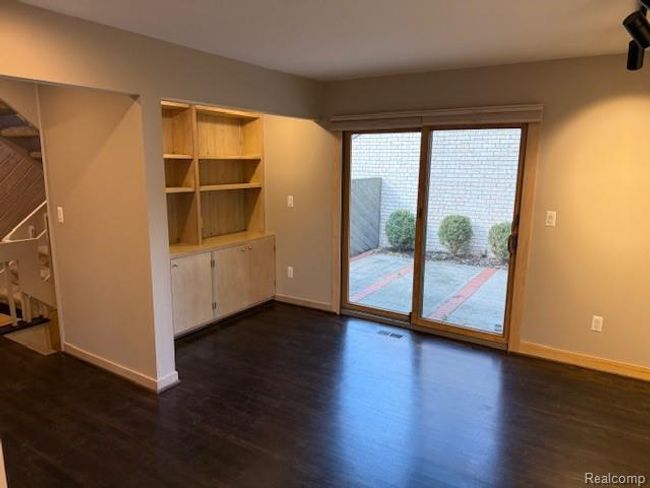 Unfurnished dining area featuring dark wood-style flooring and baseboards | Image 8