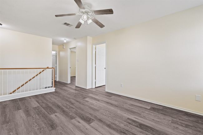 Unfurnished room with wood finished floors, a ceiling fan, and baseboards | Image 34