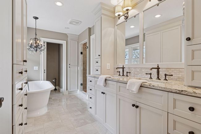 Beautiful updated Master Bath with custom built in's, toilet room and walk in shower. | Image 17