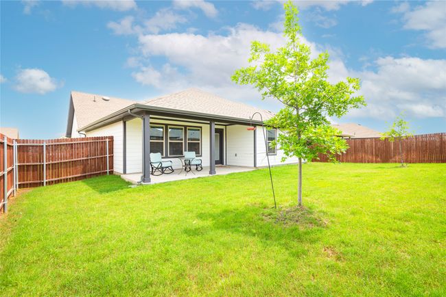 Back of property featuring a fenced backyard, a patio, and roof with shingles | Image 26