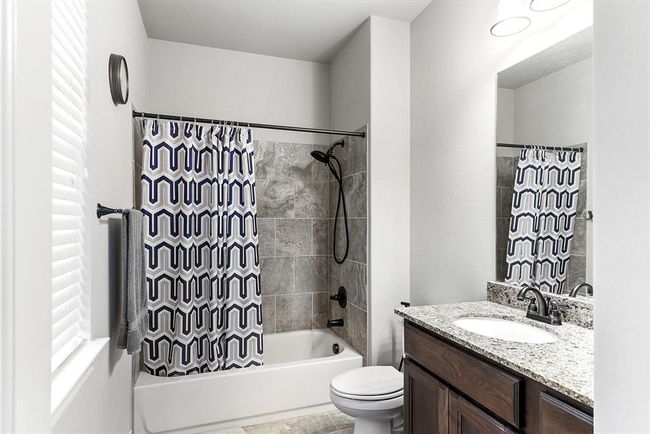 This fully attached guest bathroom is connected to the junior en suite, featuring a tub-shower combo, a full sink, and additional cabinet storage for added convenience. | Image 43