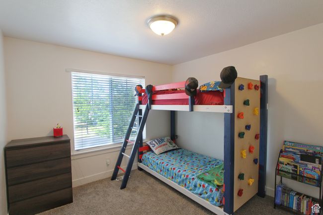 Carpeted bedroom featuring multiple windows | Image 21