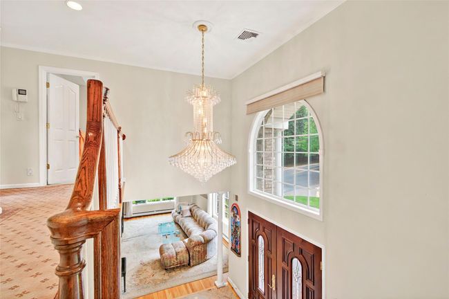 Foyer with a chandelier, baseboards, and crown molding | Image 26