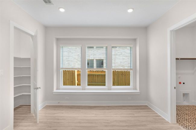 Unfurnished bedroom featuring a spacious closet, a closet, light wood finished floors, baseboards, and recessed lighting | Image 10