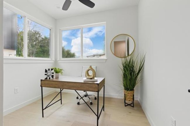 Home office featuring baseboards, a ceiling fan, and light wood finished floors | Image 7