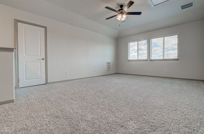 Carpeted empty room featuring a ceiling fan and baseboards | Image 20