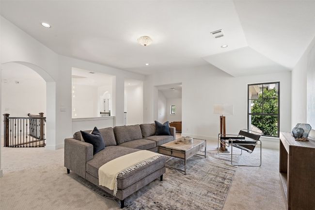 Living room with light colored carpet, arched walkways, and recessed lighting | Image 31