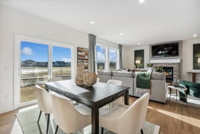 (Photo of decorated model, actual home's finishes will vary) Soaked in natural sunlight, the homes eat-in dining room has ample space for a dining table located in the heart of the home. | Image 3