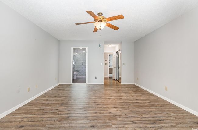 Spare room with baseboards, a ceiling fan, and wood finished floors | Image 16