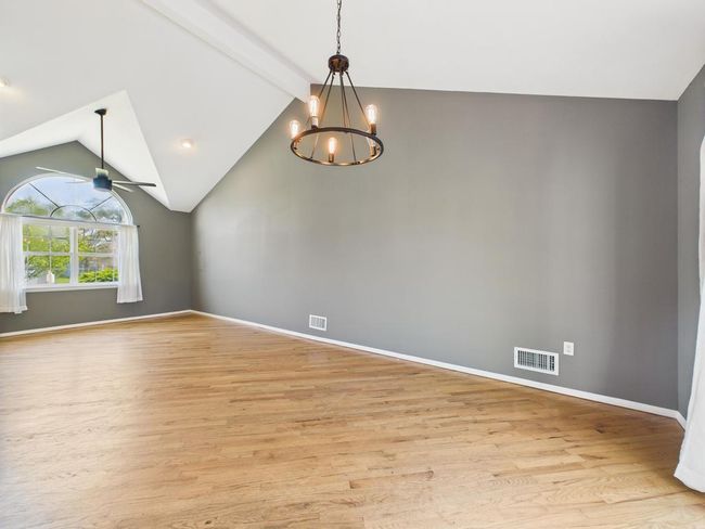 Spare room with light wood-type flooring, a chandelier, and a ceiling fan | Image 16