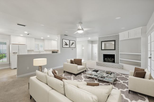 Living room featuring a ceiling fan, light carpet, baseboards, recessed lighting, and a brick fireplace | Image 14