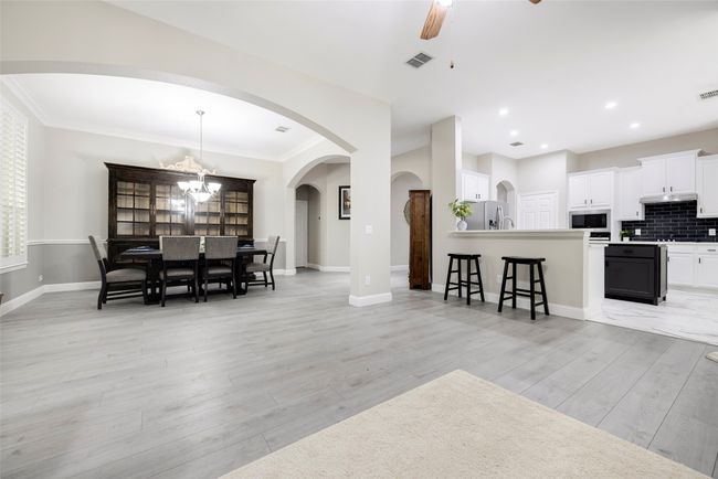 Open concept living with dedicated dining space, living, and kitchen. | Image 9