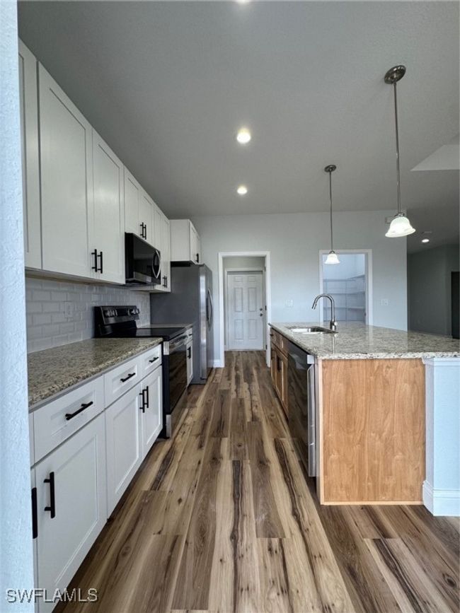 Kitchen featuring white cabinetry | Image 5