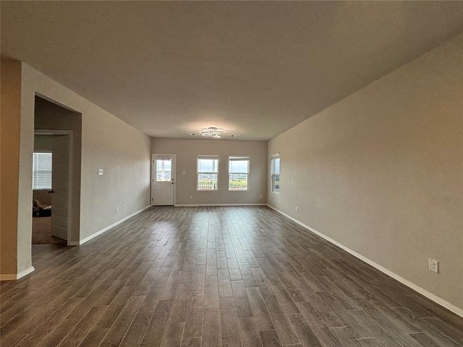 Unfurnished room featuring dark wood-type flooring and baseboards | Image 15