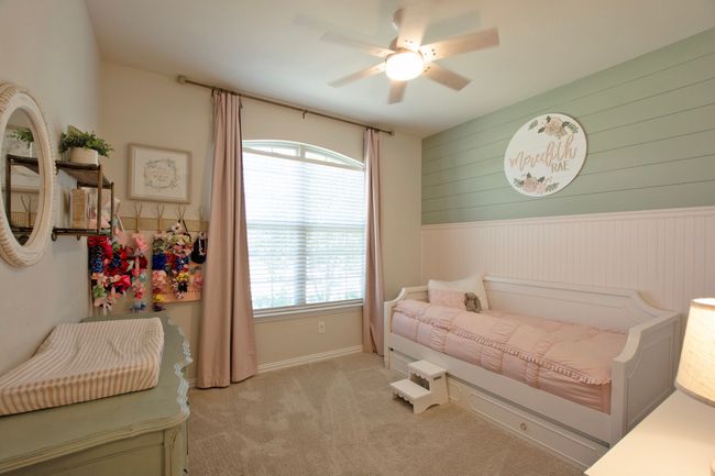 Bedroom with carpet, wainscoting, wooden walls, and multiple windows | Image 32