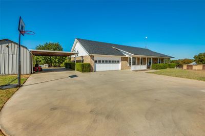 View of front of home with a carport, a front lawn, and a garage | Image 2