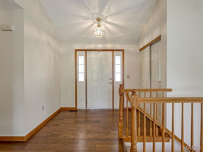 Entryway with dark wood-style flooring and baseboards | Image 6