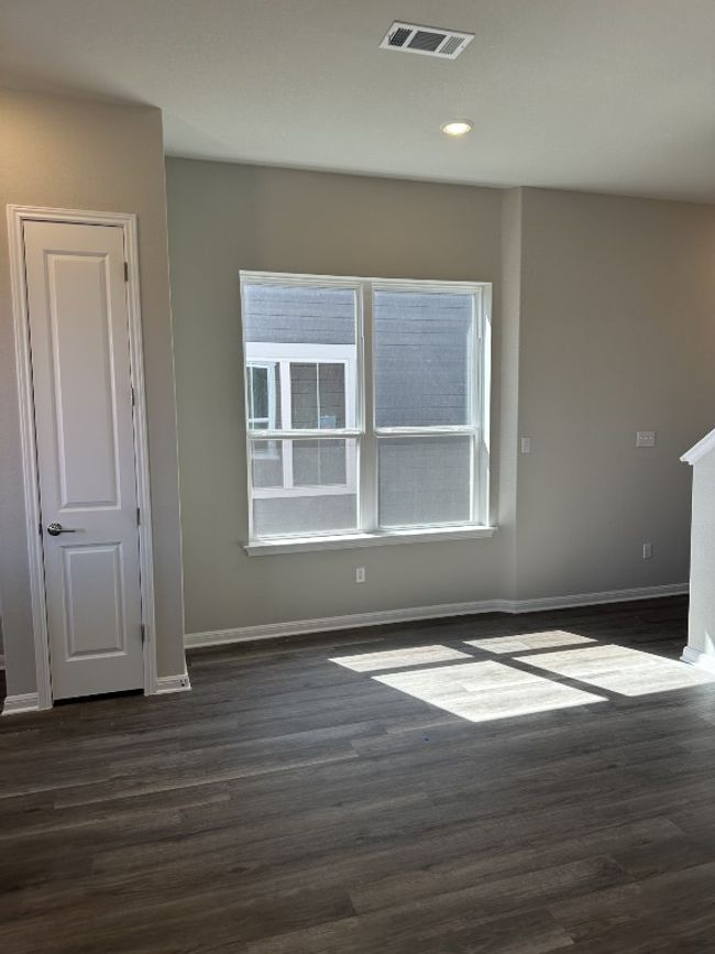 Empty room with baseboards, dark wood-style floors, visible vents, and recessed lighting | Image 4
