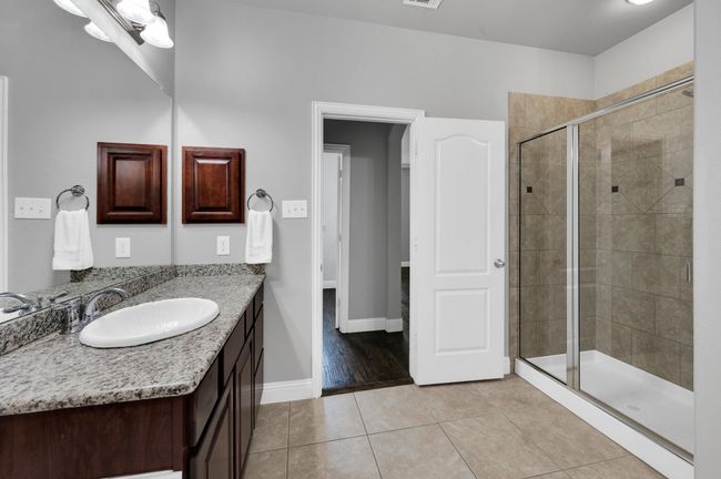 Master bath with oversized walk-in shower and granite counters. | Image 16