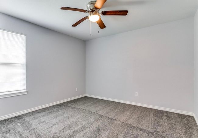 Carpeted spare room with ceiling fan and baseboards | Image 5