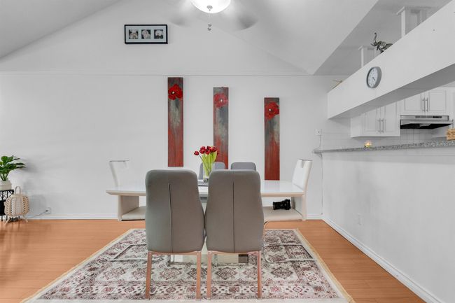 Dining space with lofted ceiling, light wood-type flooring, and a ceiling fan | Image 7