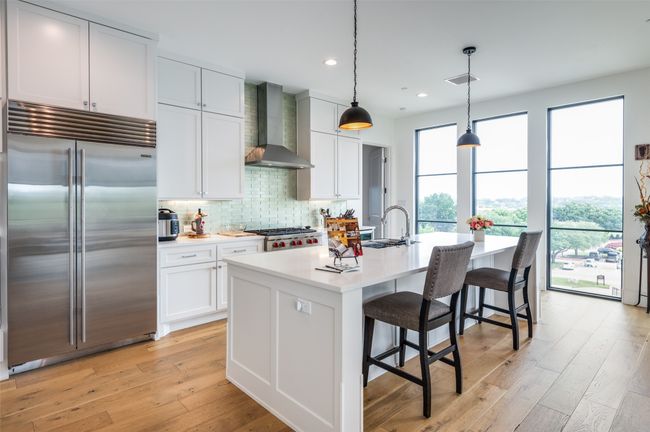 Light and bright kitchen with sub-zero, eat in kitchen at huge island | Image 12