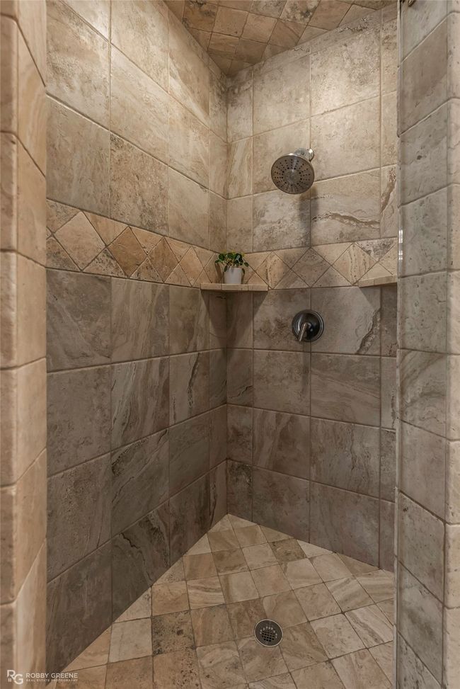 Separate master shower is oversized with plenty of shelving. | Image 16
