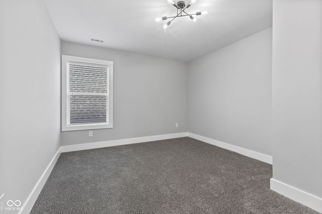 BR2 with baseboards, dark colored carpet, visible vents, and an inviting chandelier | Image 24
