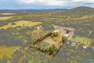 Overhead shot of property with barn, pond, and house. | Image 2