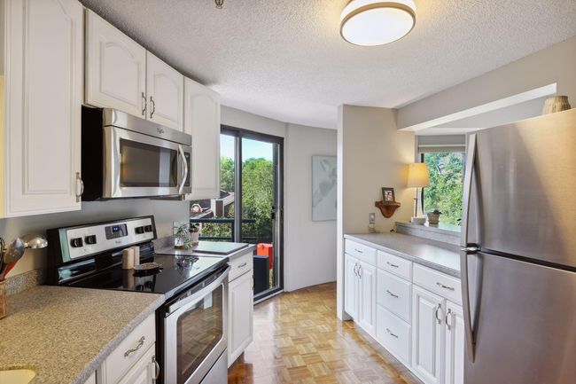 Easy access to the private balcony from either the kitchen or living room. | Image 11