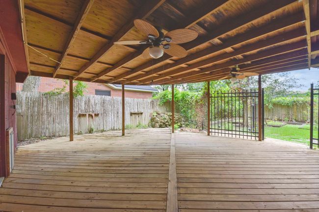 Enjoy the spacious covered patio, enhanced by a charming water feature ready for restoration. | Image 26
