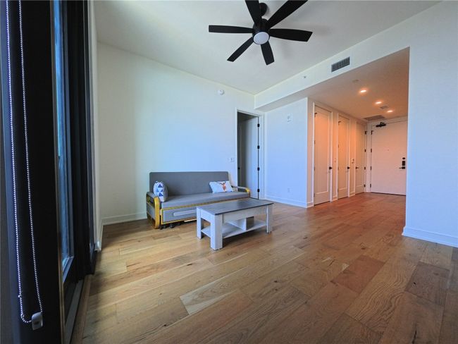 Living room with wood finished floors, ceiling fan, and recessed lighting | Image 5