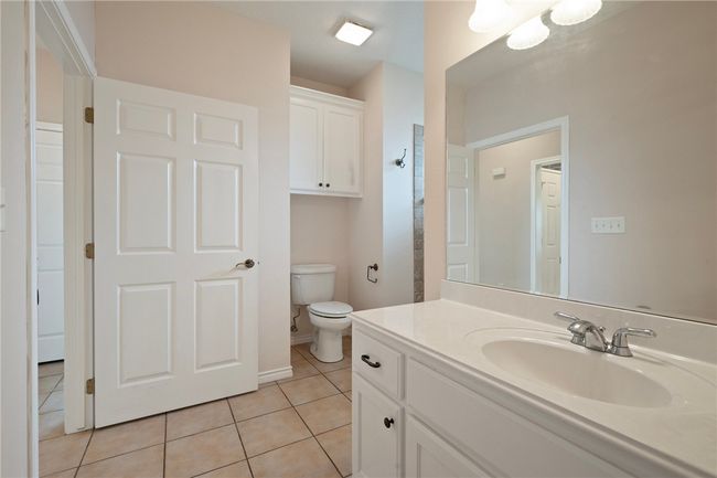 Bathroom featuring vanity, tile patterned flooring, toilet, and baseboards | Image 15