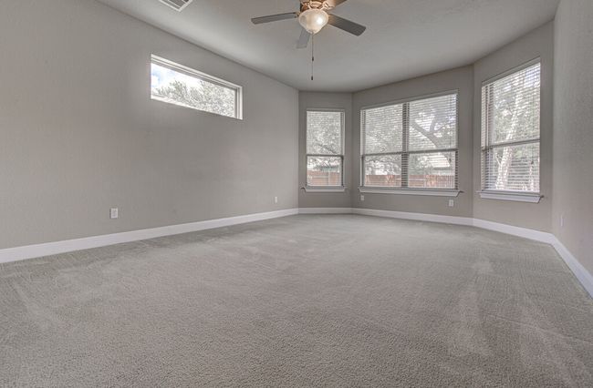 Carpeted spare room with ceiling fan and healthy amount of natural light | Image 14
