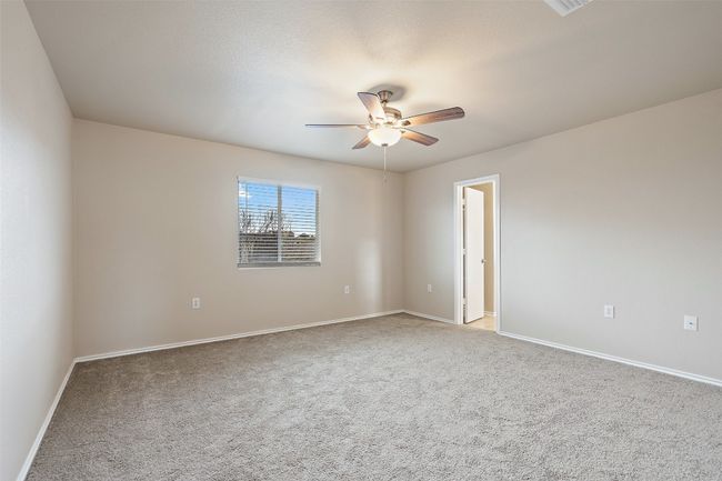 Unfurnished room with a ceiling fan and carpet | Image 19