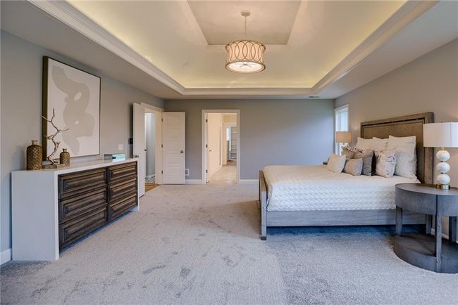 Bedroom with carpet and a raised ceiling | Image 30