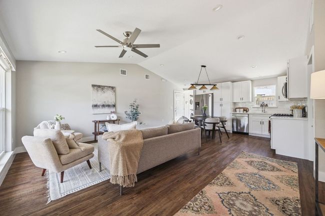 Living area featuring vaulted ceiling, a ceiling fan, dark wood-style floors, and recessed lighting | Image 6
