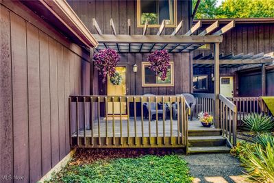 Entrance to property with a pergola, an outdoor hangout area, and a wooden deck | Image 3