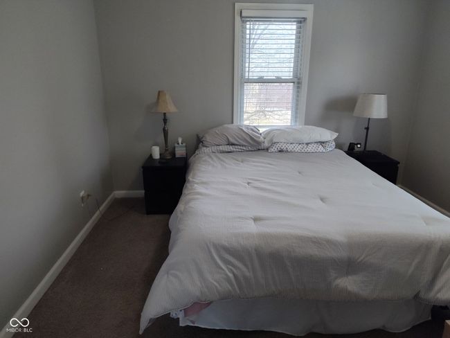 carpeted bedroom featuring baseboards | Image 11