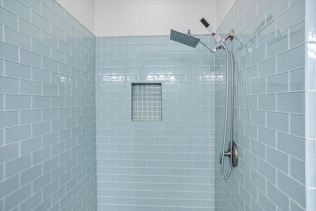 Bathroom featuring a tile shower | Image 10
