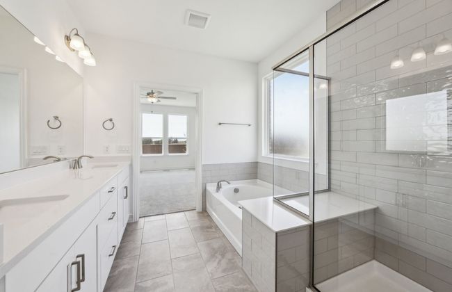 Modern owner's bath with dual vanities and a spacious shower *Real home pictured | Image 12