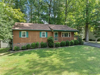 Single story home featuring a front lawn and covered front porch | Image 2