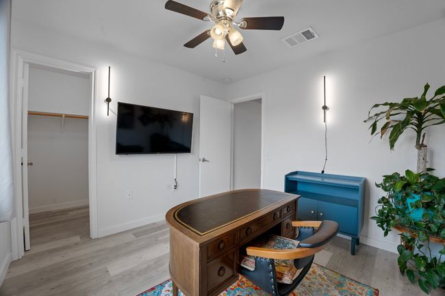 Office featuring light wood-style flooring and ceiling fan | Image 26