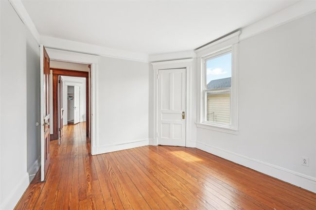 Spare room featuring light wood finished floors and baseboards | Image 17