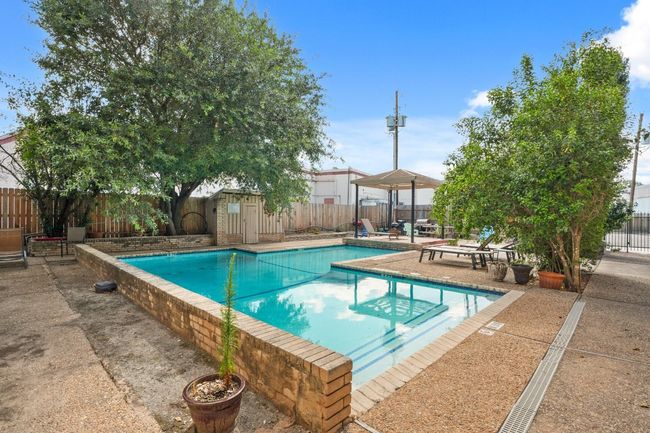 View of pool featuring a fenced backyard and a patio area | Image 32