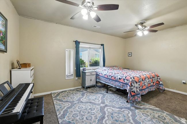 Bedroom featuring carpet floors and ceiling fan | Image 13